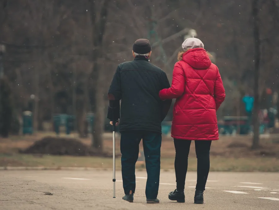 A caregiver on a walk with a senior
